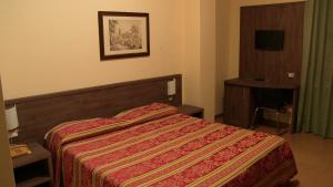 Letto o letti in una camera di Hotel Due Pini