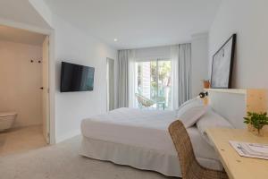 a hotel room with a bed and a television at HM Ayron Park in Playa de Palma