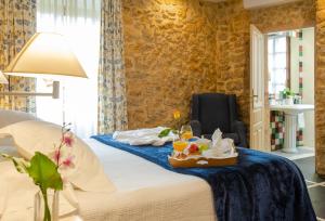 a hotel room with a bed with a tray of food on it at Hotel Palacio De La Viñona in Oviedo +47 photos