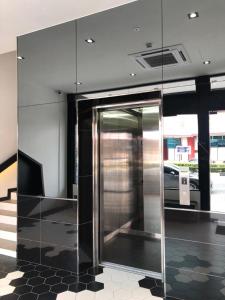 a metal elevator in a room with a building at ARENA Boutique Hotel Kuala Terengganu in Kuala Terengganu