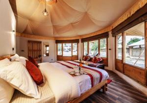 a bedroom with a large bed in a tent at Chalet Seabuckthorn - Hunder in Hundar