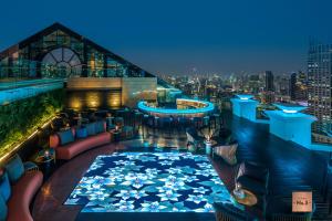 a rooftop bar with a view of the city at night at Tower Club at lebua - SHA Extra Plus in Bangkok