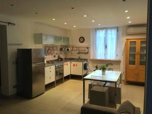 a kitchen with a stainless steel refrigerator and a table at LOFT 51 in Pescara