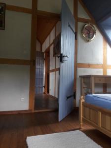 a room with a bed and a wooden door at Ferienhaus Brotenfeld in Brotenfeld