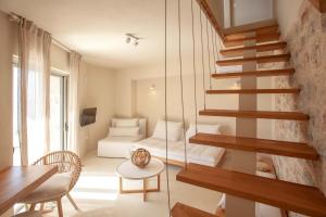 a living room with a staircase and a bedroom at Katikies Manis Suites in Kardamili