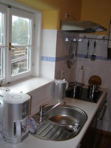 a kitchen counter with a sink and a window at Ferienhaus Brotenfeld in Brotenfeld