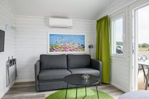 a living room with a couch and a table at First Camp Kärradal-Varberg in Varberg