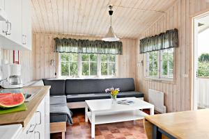 a living room with a couch and a table at First Camp Kärradal-Varberg in Varberg