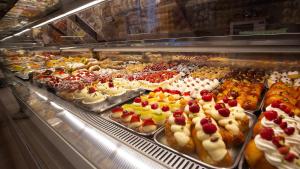 a display case filled with lots of different types of desserts at Duomo Luxury Suite Catania in Catania