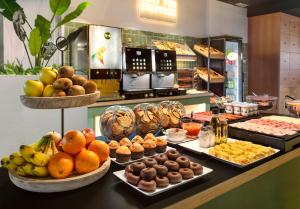 a buffet with many different types of food on a counter at B&B HOTEL Castellón in Castellón de la Plana