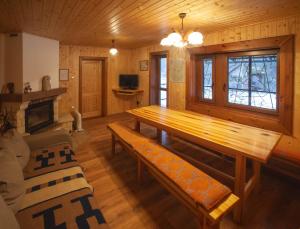a living room with a wooden table and a couch at Chata Smiech in Ružomberok