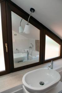 a bathroom with a white sink and a bath tub at B&B Villa Setharè in Salerno