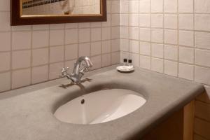 a bathroom sink with a silver faucet on a counter at B&B Palazzo Al Torrione 2 in San Gimignano