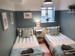 a bedroom with two beds and a window at Apartment with Swimming Pool in Tenby