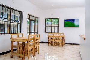 a dining room with a table and two chairs at Wanyama B&B in Arusha