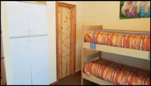 a room with two bunk beds and a closet at trilocale sulle piste da sci in Abetone