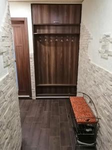 a walk in closet with a bench next to a door at У Ксені in Morshin