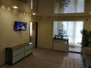 a living room with a tv on the wall at У Ксені in Morshin