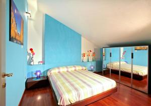 a bedroom with two beds and a blue wall at Villa Quaranta in Portici