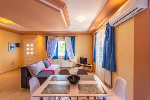 a living room with a couch and a table at Demmy's Apartment in Potamiá
