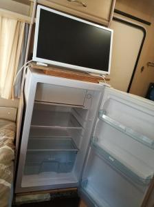 
an open refrigerator with its door open at Camping el Pinar Platja in Santa Susanna
