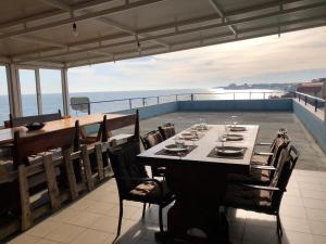 a table on a balcony with a view of the ocean at Autentic Boutikue in Costinesti