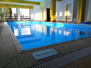 a swimming pool with a sign in the middle of it at Vital & Wellnesshotel Schuerger in Thurmansbang