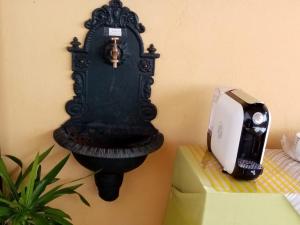 a black clock on the wall next to a printer at B&B La Cupella in Monterotondo