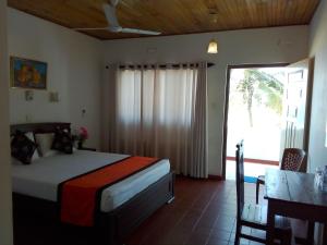 Postelja oz. postelje v sobi nastanitve New SeaSide Inn Hikkaduwa