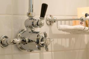 a chrome shower faucet in a bathroom at Boetiekhotel Hemelhuys in Hasselt