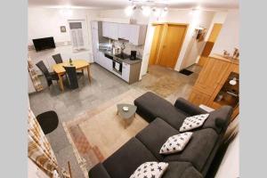 a living room with a couch and a kitchen at Ferienwohnungen Saida Wohnung 1 in Norden