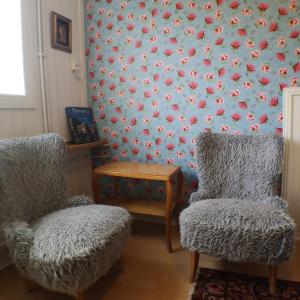 two chairs and a table in a room with a wall at Varbergs Vandrarhem in Varberg +30 photos