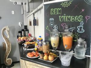 a counter with some food and drinks on it at Pousada Bonanza in Arraial do Cabo