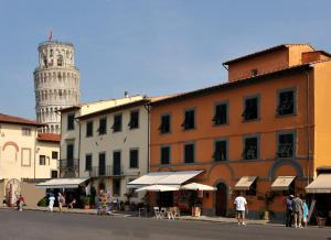 a street with a tower and a building with a clock tower at Il Campanile II Locazione Turistica in Pisa