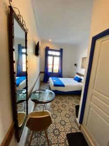 Postel nebo postele na pokoji v ubytování Hôtel Central