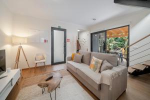 a living room with a couch and a table at Oscar's House by An Island Apart in Ponta do Sol