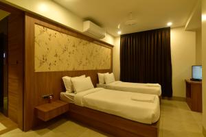
a hotel room with a bed and a desk at Panchavati Express in Nashik
