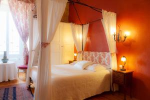 a bedroom with a canopy bed and a window at Chateau de Murviel in Murviel