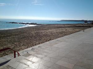 a sandy beach with a pier in the ocean at casita bonita in Vinaròs