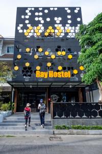 two people walking up the stairs to a new hospital at Ray Hostel in Chiang Mai