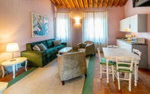a living room with a couch and a table at Le Sodole Country Resort & Golf in Pontedera