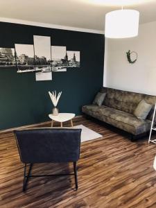 a living room with a couch and a table at Ferienwohnung Willi I in Spremberg