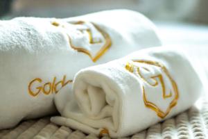 a folded towel with the name gold on it at Golden Zaan Hotel, Zaandam-Amsterdam in Zaandam