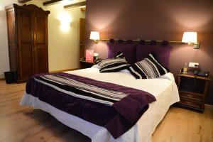 una camera da letto con un grande letto con cuscini sopra di Hotel Cardenal Ram a Morella