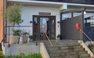 a front door of a building with a sign on it at Hotell Hanöbris på Kivik in Kivik