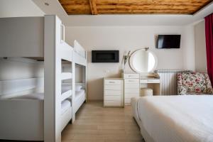 a bedroom with a bunk bed and a mirror at Archontiko Liamas in Stavros