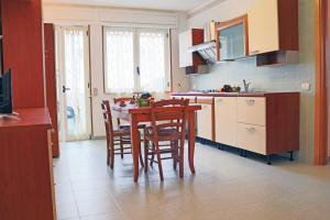 a kitchen with a table and chairs in a room at Holiday Apartment Karm Otranto 6 places in Otranto +4 photos