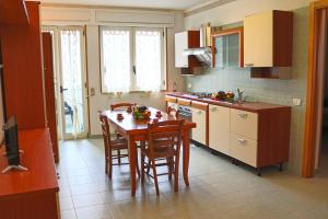 a kitchen with a table and chairs in a kitchen at Holiday Apartment Karm Otranto 6 places in Otranto