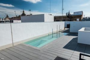 a swimming pool on the roof of a building at Welldone Quality - Crystal pool in Seville
