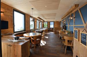a restaurant with wooden floors and tables and chairs at Berggasthaus Eggberge in Altdorf